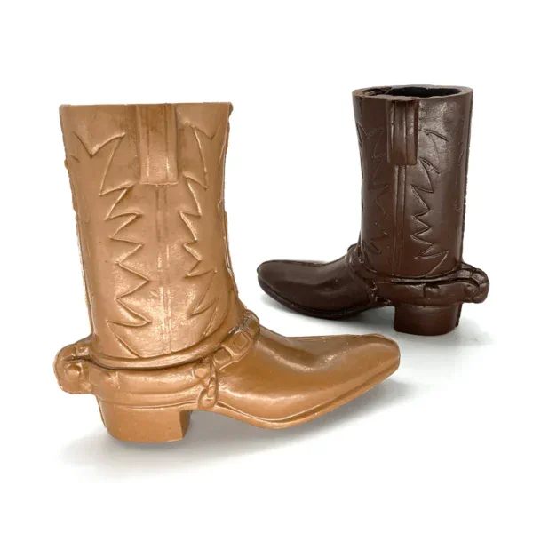 two cowboy boots. One is light brown and the other is dark brown representing milk and dark chocolate, respectively.