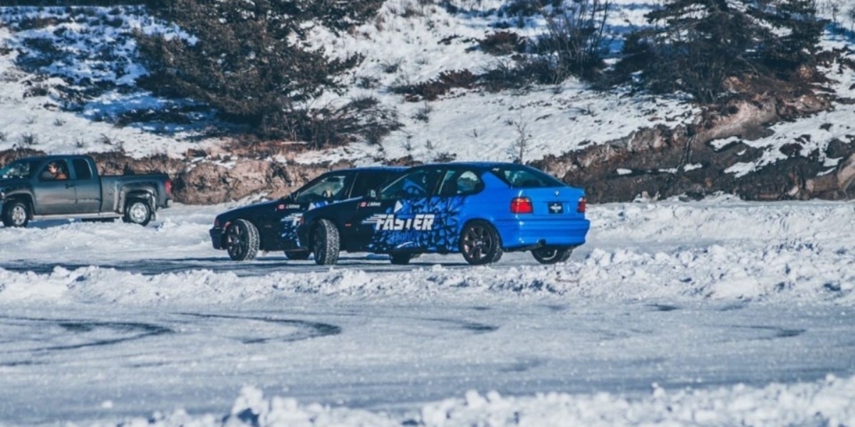 Two drift cars racing on the snow covered Ghost Lake racetrack