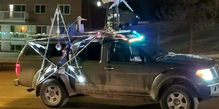 a photo of the Yellowhead Amateur Radio Association's vehicle with a wind generator mounted on the room and Christmas decorations on the doors