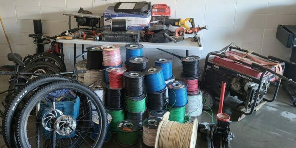 A picture of the stolen goods showing bike tires, electrical wires, a generator, and many other items