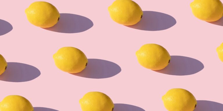 an image if lemons on a pink background