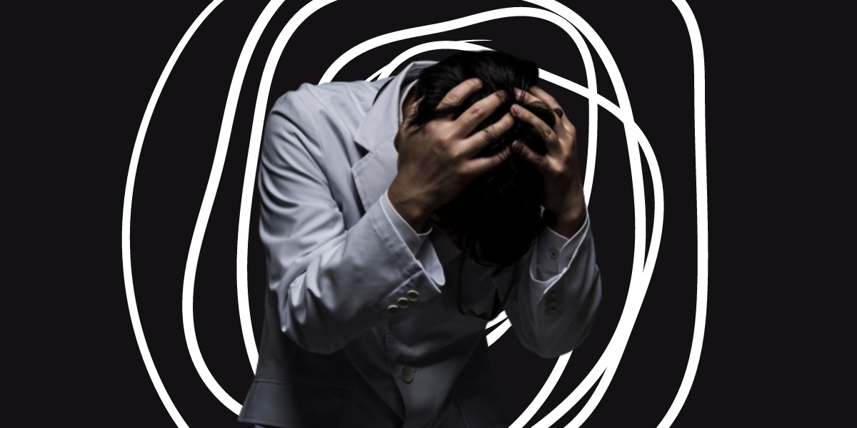 a doctor holding his head with white lines around him indicating stress