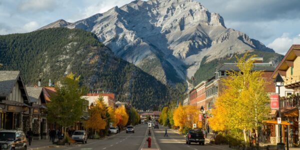 a beautiful photo of banff in what looks like fall with the mountain the background and buildings in the foreground