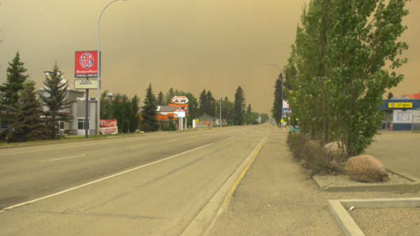 a gloomy image of an abandoned edson with smoke from a nearby wildfire blocking out sunlight