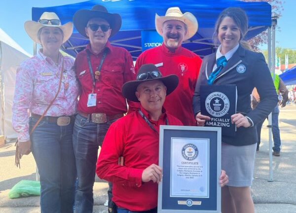 Calgary Stampede volunteers posing with their hard earned Guinness World Record for pancakes served