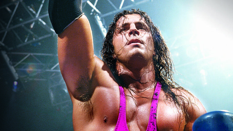 a young bret hart in his pink uniform with a spotlight behind him