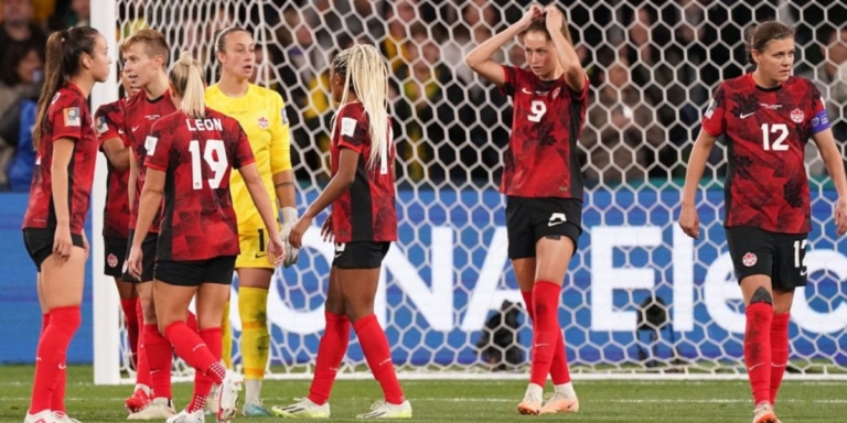 a photo of the canada womens team looking distressed after a goal from australia