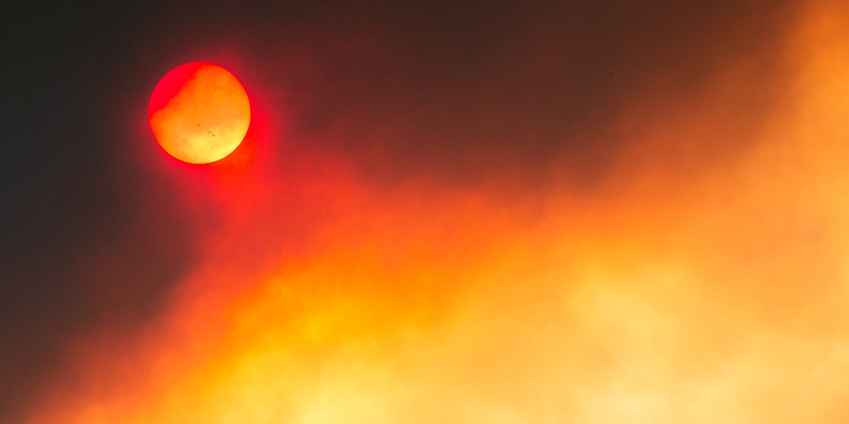 photo of the sun obscured by thick forest fire smoke