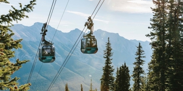 a photo of the blue banff gondolas with a backdrop of the rockies
