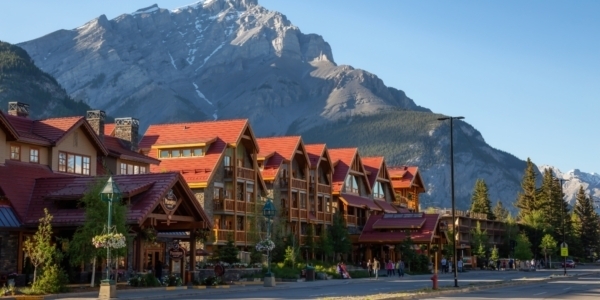 the banff townsite with orange roofed houses and the rockies in the background