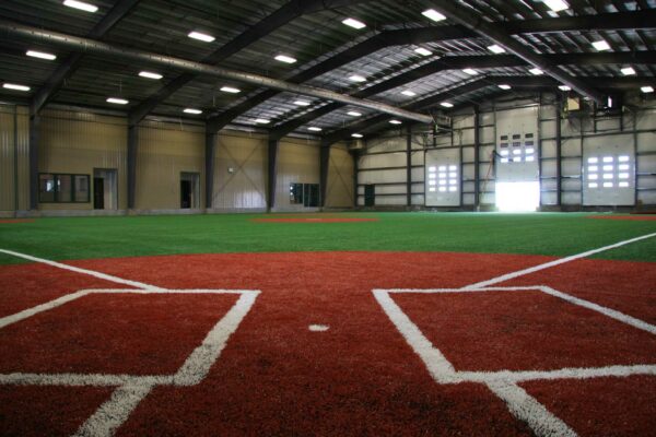 an indoor pitch inside a large well lit warehouse