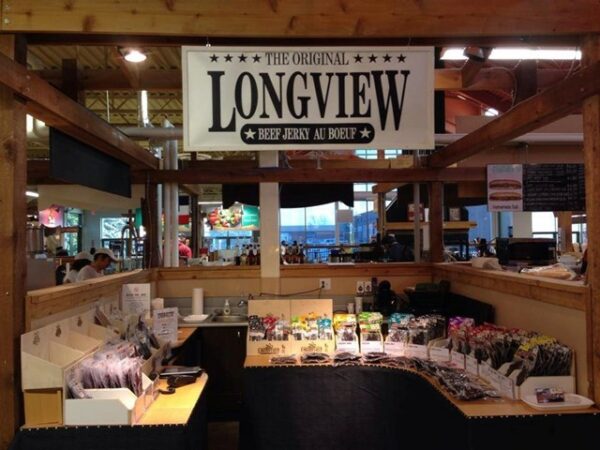 the interior of the longview jerky shop showing a wide array of options and a sign hanging overhead