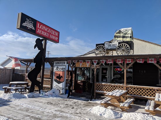 the outside of the longview jerky shop with the silhouette of a cowboy leaning against the shops sign