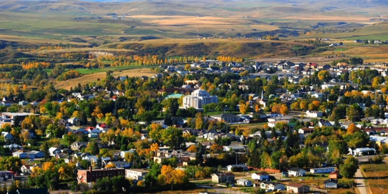 aerial photo of cardston in the fall with different colored trees