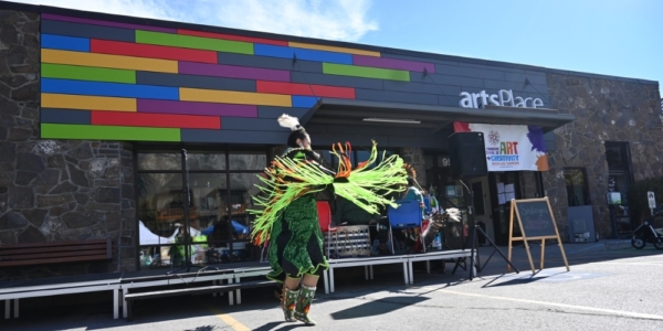 artsplace in canmore with a person dancing outside the entrance of the building