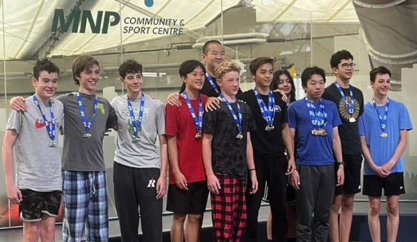 a group of boys from the cochrane piranhas swim club with medals around their neck