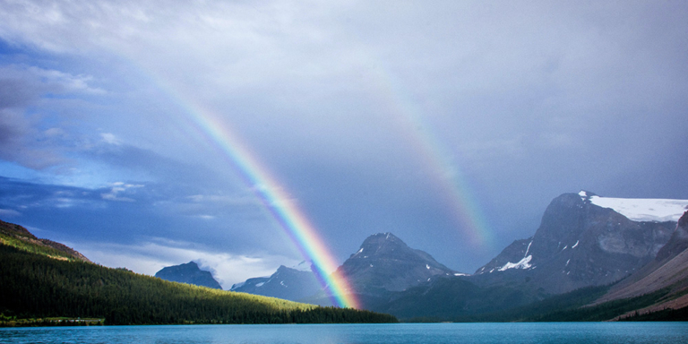 Double rainbow over a mountain lake