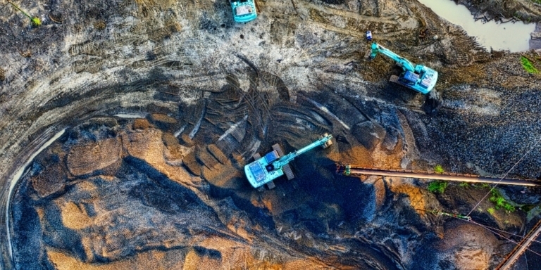 aerial shot of a mine with blue excavators