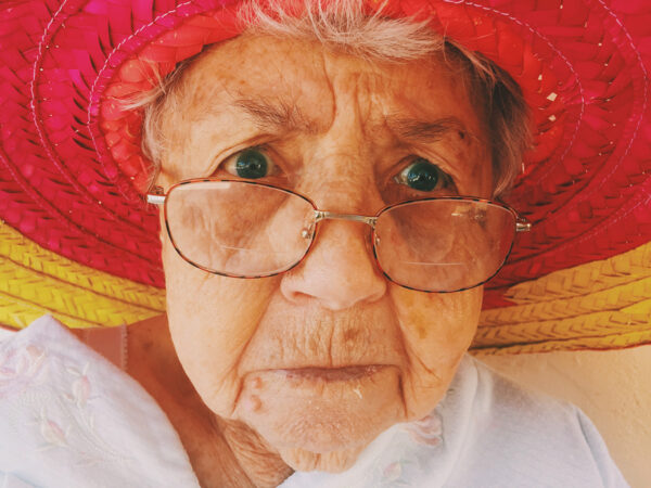 Closeup of an elderly woman's face which looks grumpy