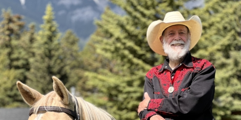 photo of bearded older man on horse