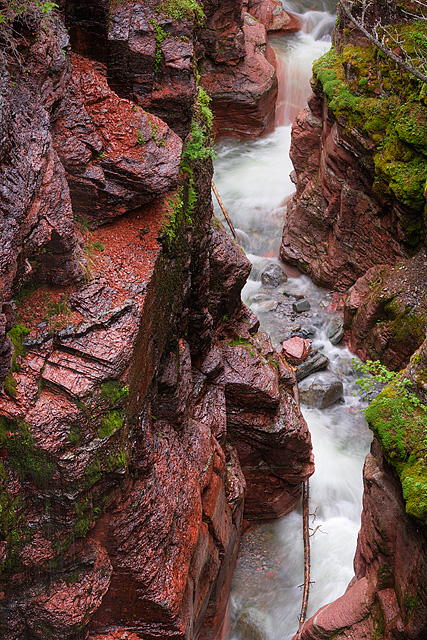 an aerial view of the red rock walls and stream at Red Rock Canyon in Waterton National Park