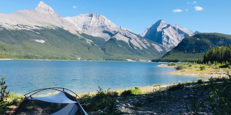 photo of tent along mountain lake