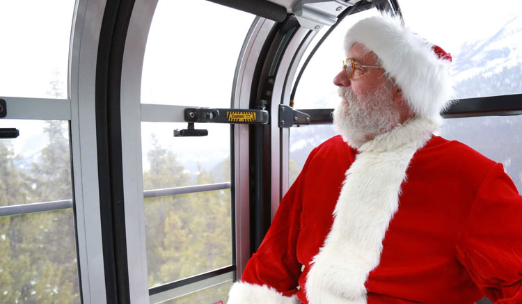 Santa on his way up the Sulphur Mountain Gondola to celebrate Moutaintop Christmas | Banff Jasper Collection