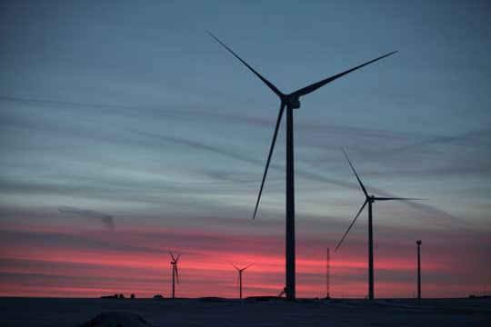 wind turbines against a sunrise sky