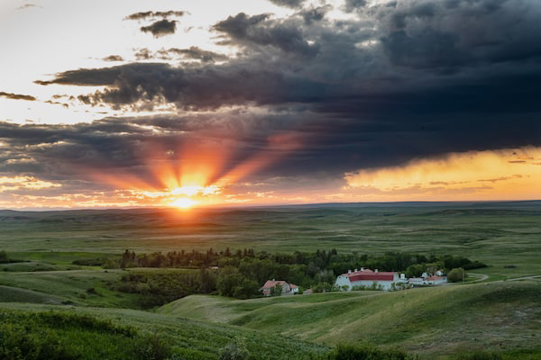 sunset over a prairie ranch