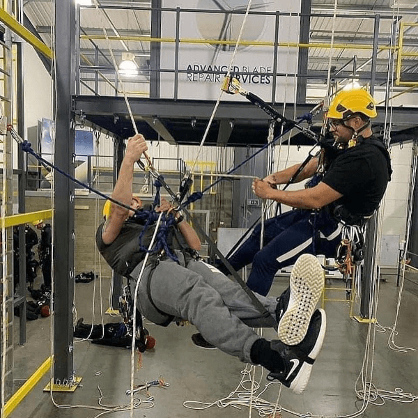 Rope access blade repair technicians working on roping techniques