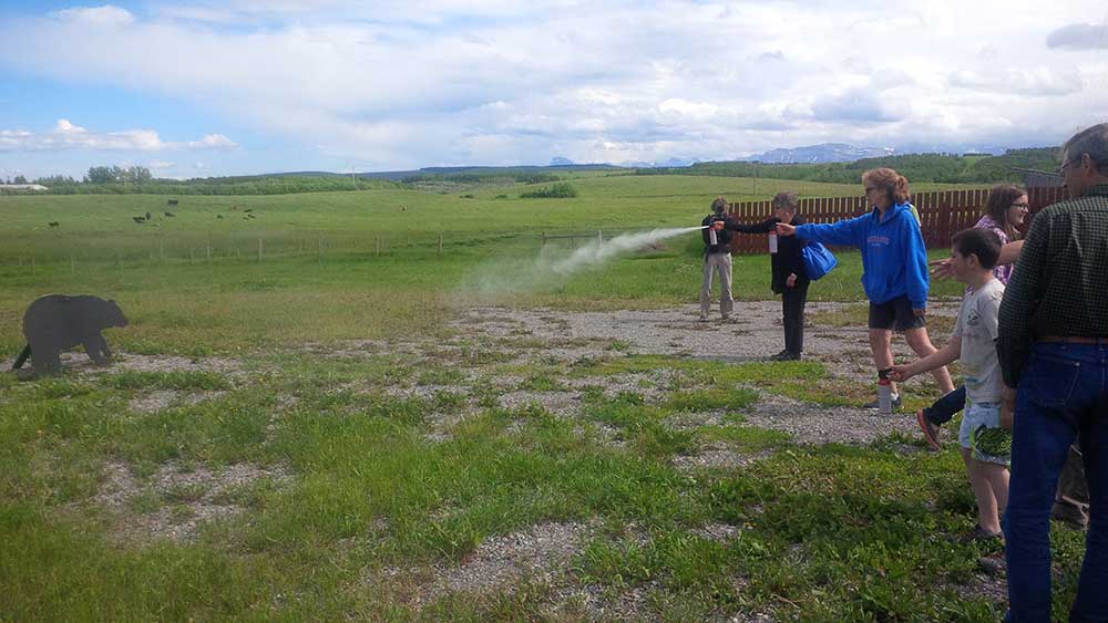 A ranch family learning how to use bear spray at the CACP Bear Safety workshop | Waterton Biosphere Region | CACP