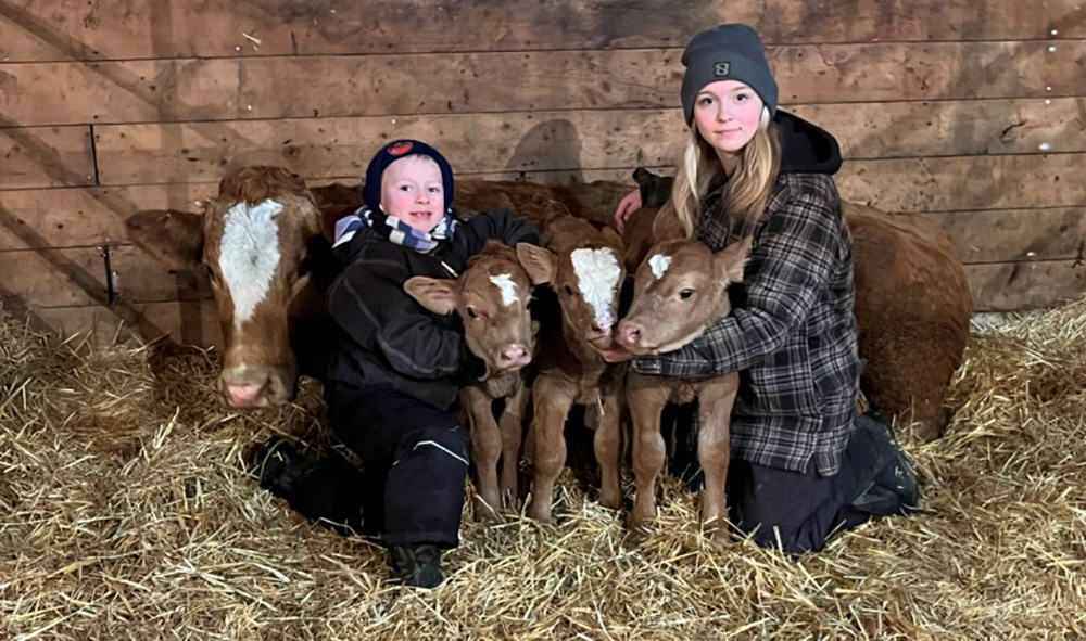 Joe and Ella Perreault with the three triplet calves | Town and Country Today