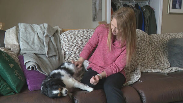 Tanya Barkley with her dog at their home in Calgary  Global News
