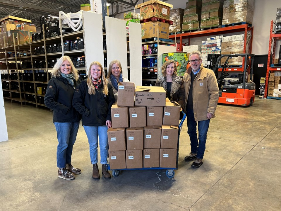 Brenda and Brekell Otto (left) from Tangle Ridge Ranch, Executive Foodbank Director Bente Yanota (middle) and Shelly Faulkner and Jay Cross(right), pictured with the 600 pounds of donated beef | Okotoks Food Back Association, Facebook
