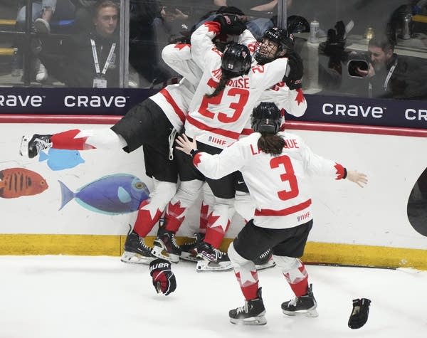 Team Canada celebrating their 6-5 win over the US Christinne Muschi  The Canadian Press  MPR News