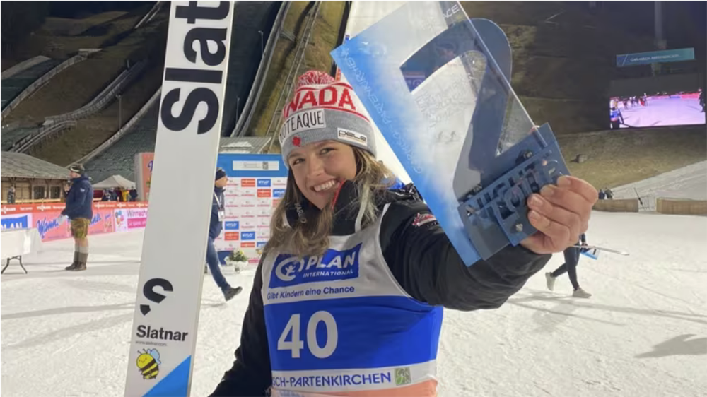 Strate posing for a photo after winning bronze at the women's World Cup ski jumping competition