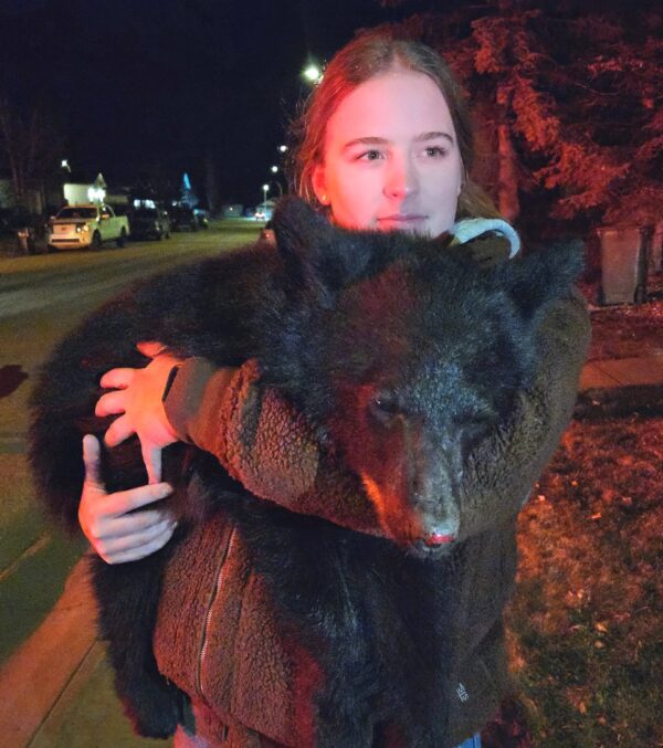 Woman holding a bear cub