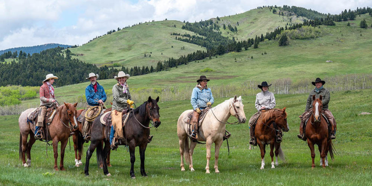 Cowboys on horses at Bob Creek Ranch in Alberta