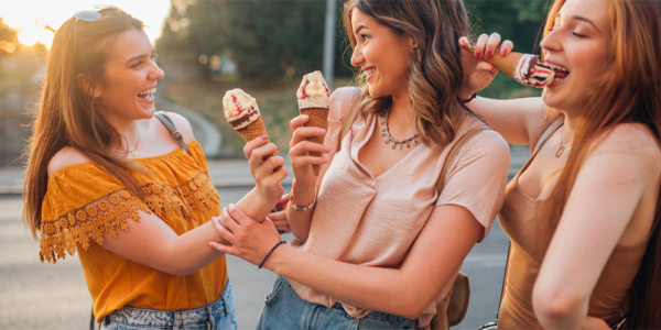 Girls smiling and eating ice cream
